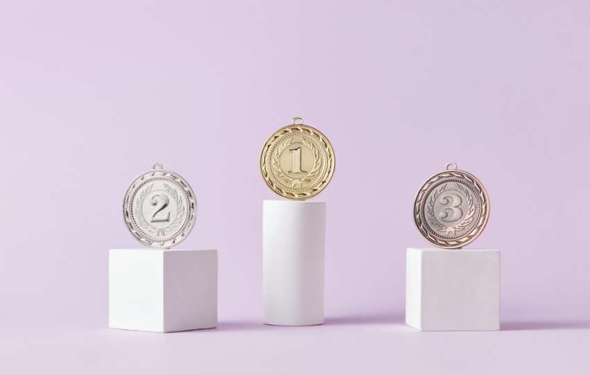 Medals on Pedestal on Pink Studio Background