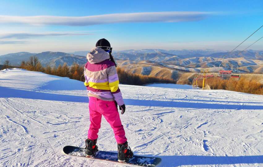 Person Snowboarding on Field