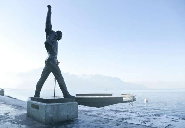 Iconic Freddie Mercury statue on Lake Geneva in Montreux, captured in a serene and foggy morning.