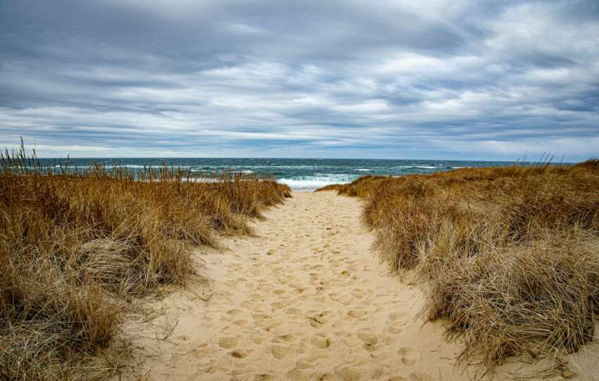 Tranquil sandy footpath leading to the ocean in Provincetown, Massachusetts.