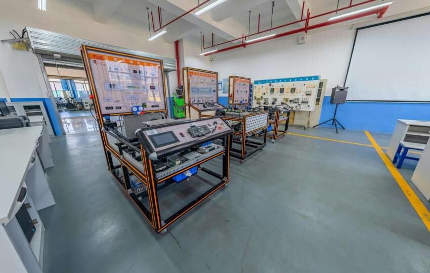 Spacious engineering laboratory equipped with advanced training systems and desks.