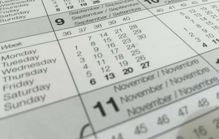 Detailed close-up of a calendar displaying months in several languages.