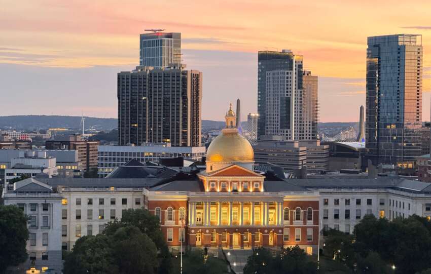 A breathtaking view of Boston's skyline with the Massachusetts State House at sunset, showcasing its iconic golden dome.